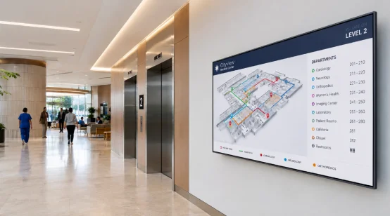 Wall-mounted digital wayfinding screen in a hospital lobby
